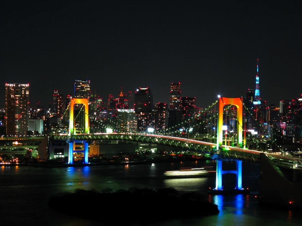 Rainbow colored Rainbow Bridge at night. Tokyo sight from Odaiba island.