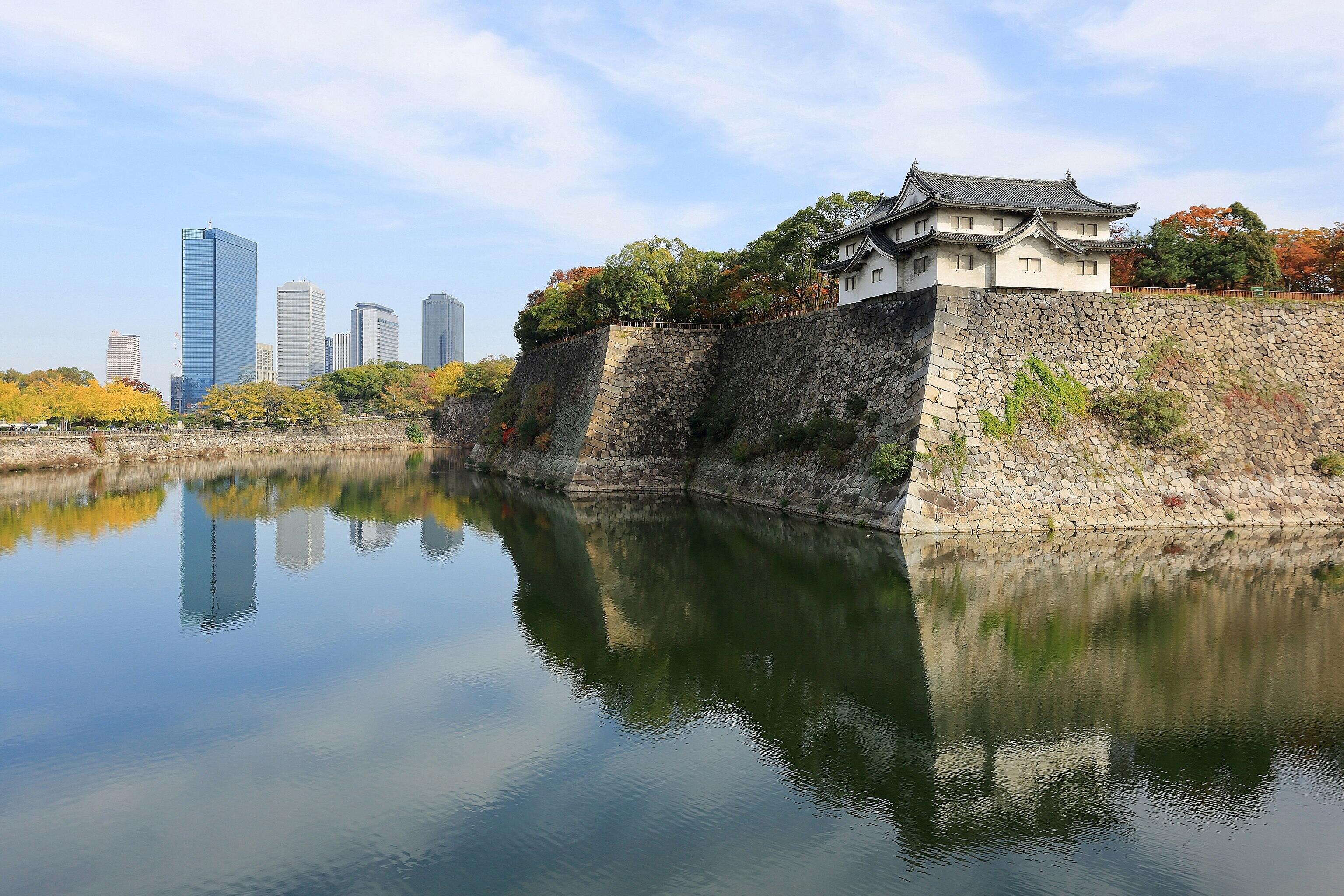 Inui-yagura Turret, guarding the outer moat of Osaka Castle and the skyline of Osaka Business Park, Osaka, Japan.