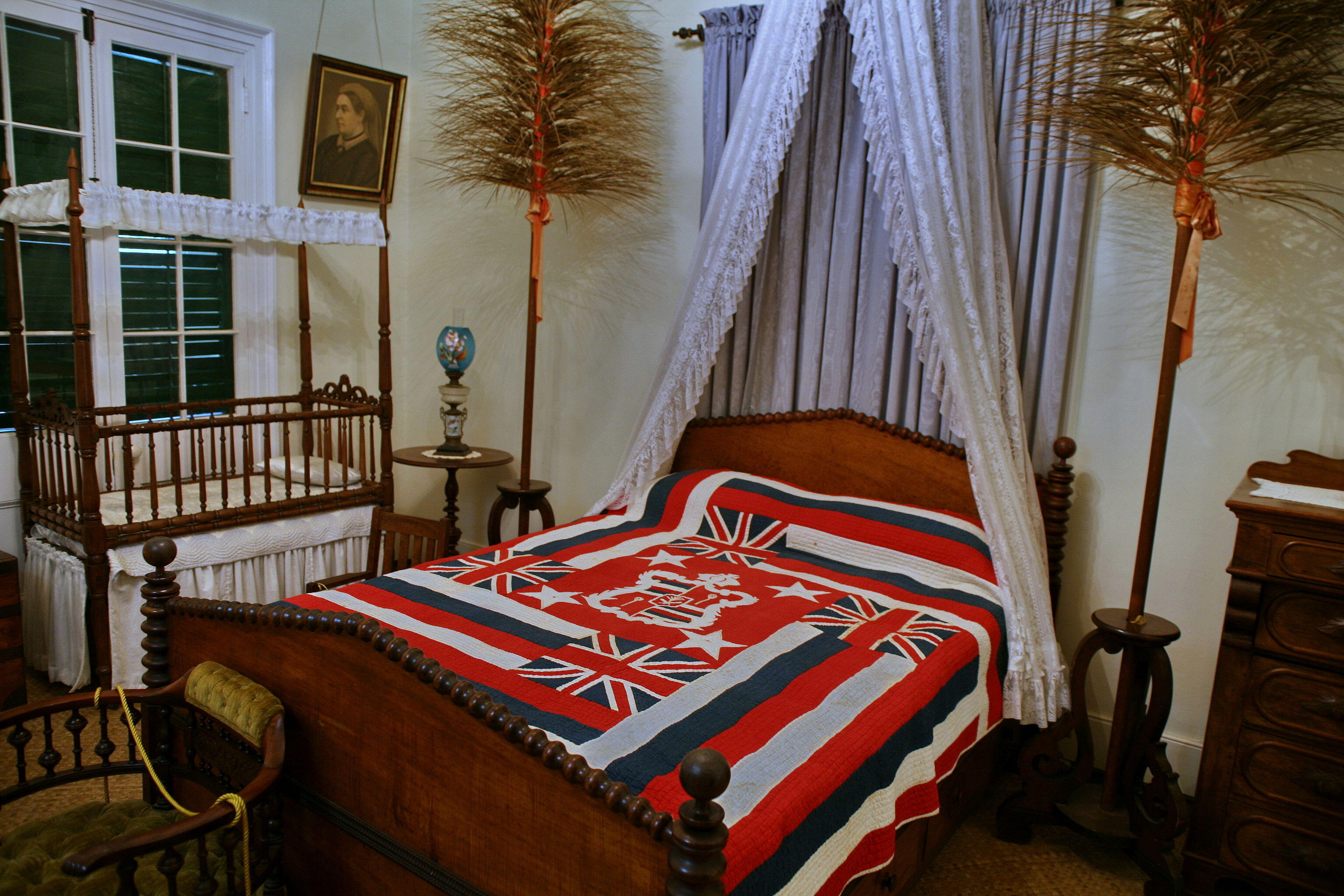 Queen Emma's koa bed with spool posts and beaded trim. 