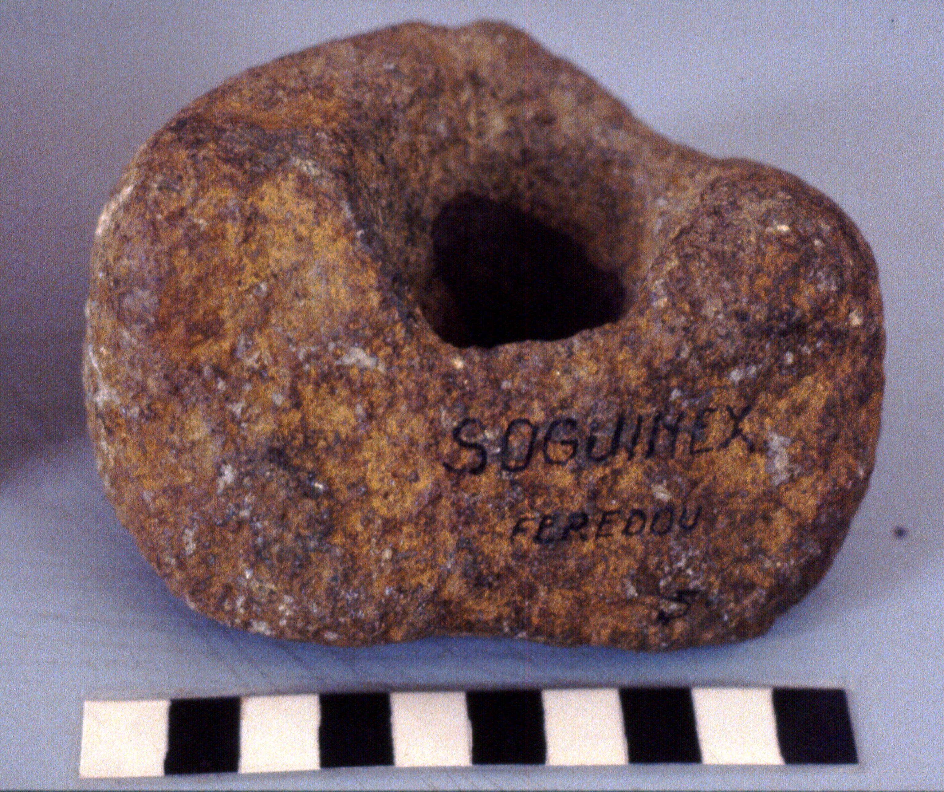 Bored stone from Guinée (west Africa) - Scale in centimetres. Photographed January 16, 1982 in the IFAN Museum, Dakar, Sénégal. From ethnographic…